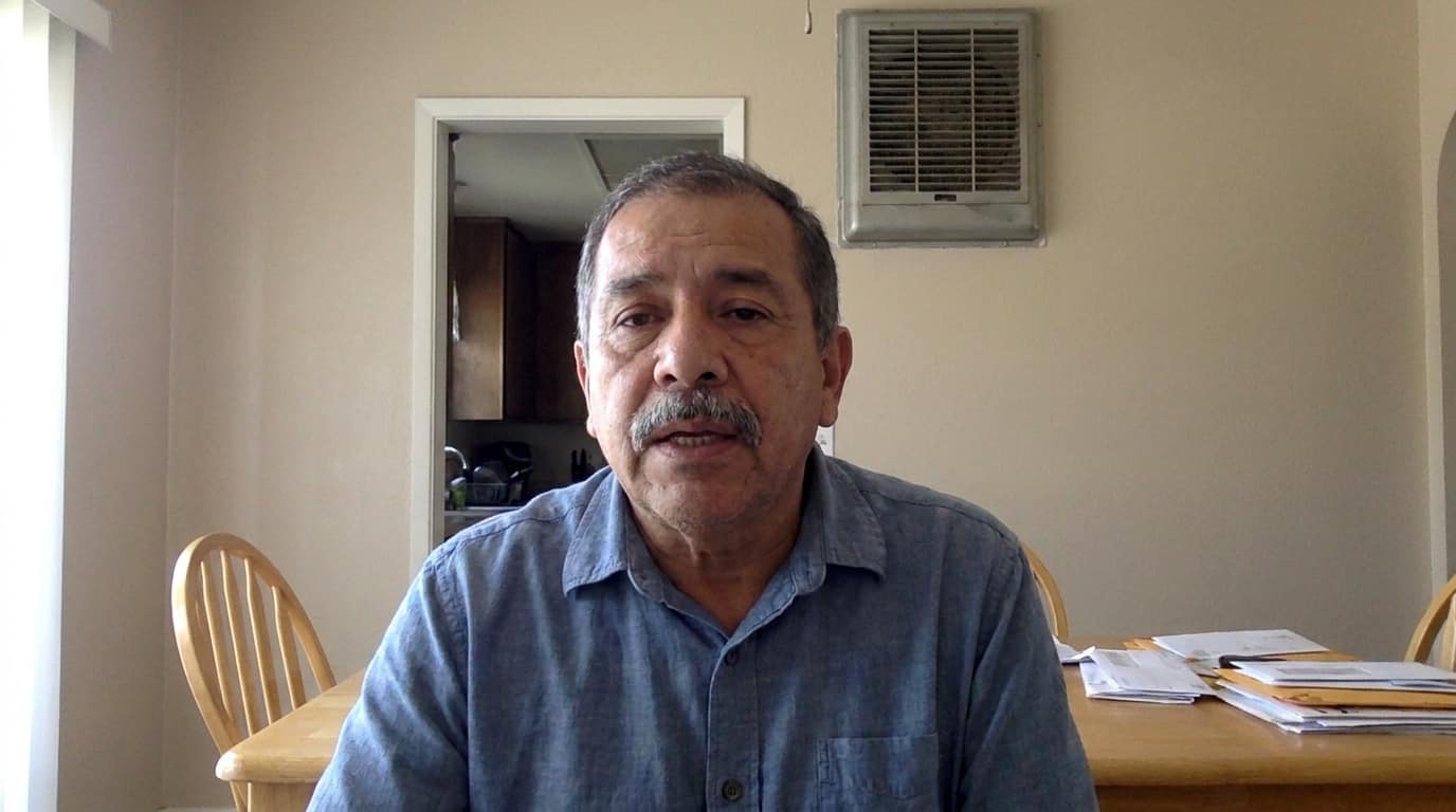 Carlos seated at his dining table in El Paso.
