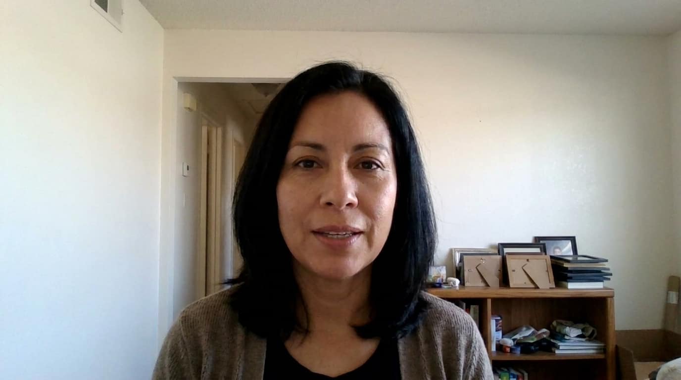 Maria seated inside her El Paso home.